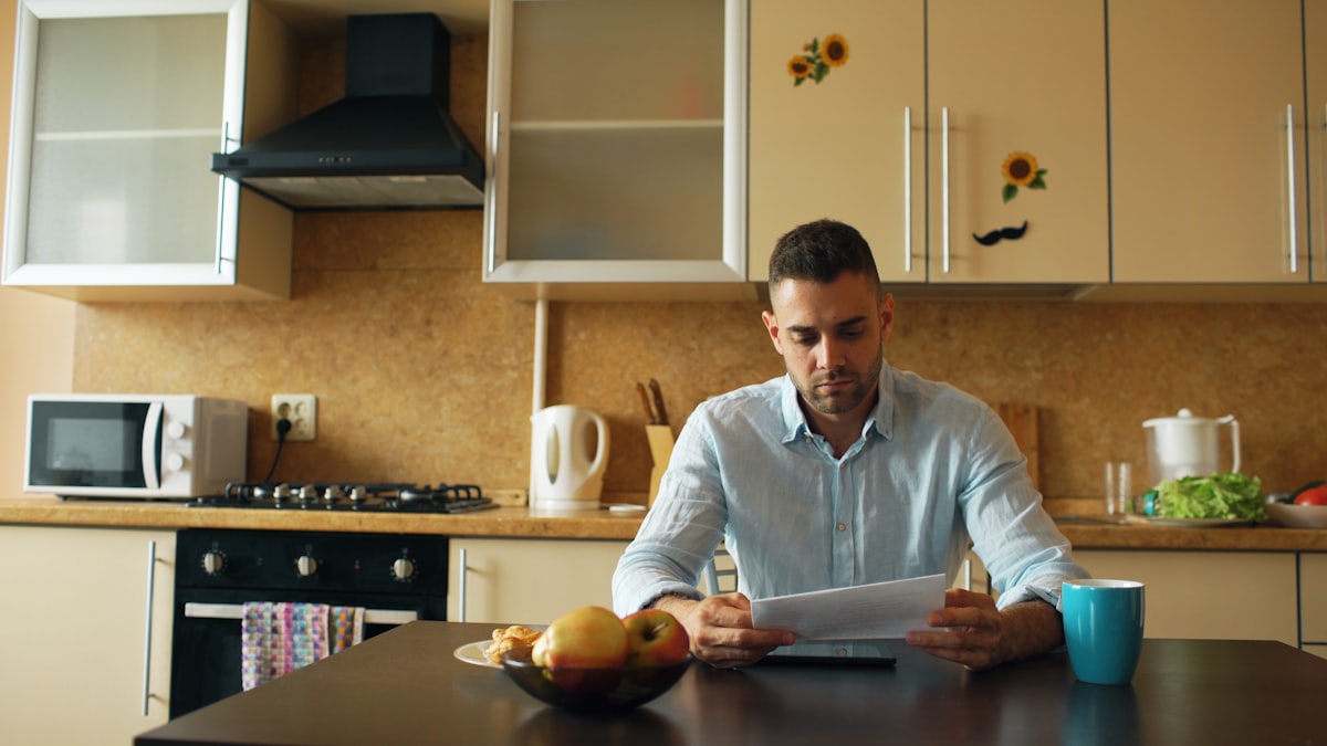 Person reviewing an electricity bill at a kitchen table