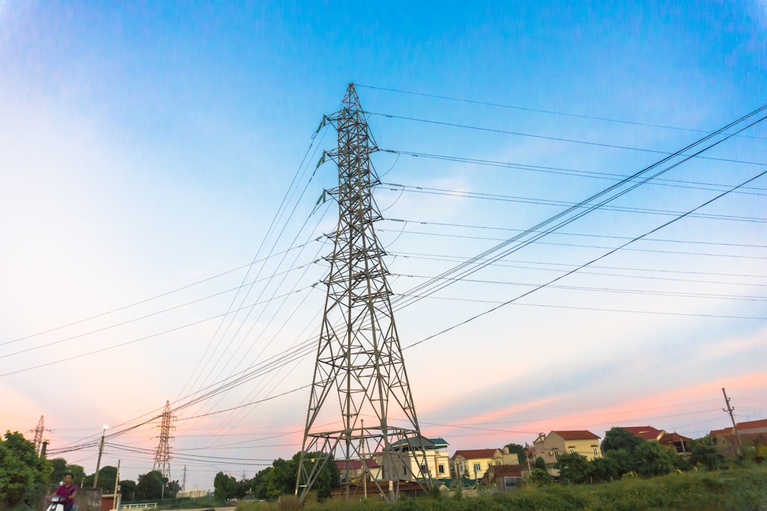 Electricity transmission tower against blue sky
